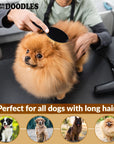 Person grooms a fluffy orange long haired dog on a table using a black pin brush. A hair dryer sits nearby and a banner says Perfect for all dogs with long hair.