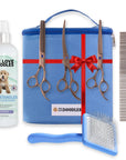 Blue zippered grooming bag with red ribbon accents shown with three bronze grooming scissors a metal comb a blue slicker brush and a white detangler bottle.