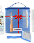Blue zip grooming bag with ribbon graphic shown with a detangler bottle a wood handle dematting rake two white and blue metal combs and a blue slicker brush on a white background.