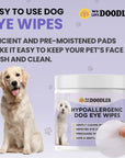 Purple graphic reads Easy to use dog eye wipes. A golden retriever sits next to the product jar while a hand holds a textured round pad in the foreground. Paw prints decorate the background.