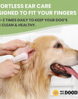 Person cleans a light golden dog's ear with a white textured finger wipe in a bright indoor setting. Headline notes effortless ear care with a tip to use one to two times daily.