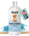 White 8 fl oz bottle labeled Puppy Shampoo extra gentle calming and tearless. A tan puppy is on the label. Waves and sand sit behind the bottle and a mint tag reads Made in USA.