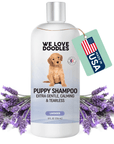 White 8 fl oz bottle labeled Puppy Shampoo extra gentle calming and tearless with a puppy on the label. Lavender sprigs surround the bottle and a green tag reads Made in USA.
