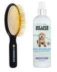 Black beechwood pin brush with gold pins next to a white 16 fl oz We Love Doodles lavender dog detangler leave in conditioner on a clean white background.