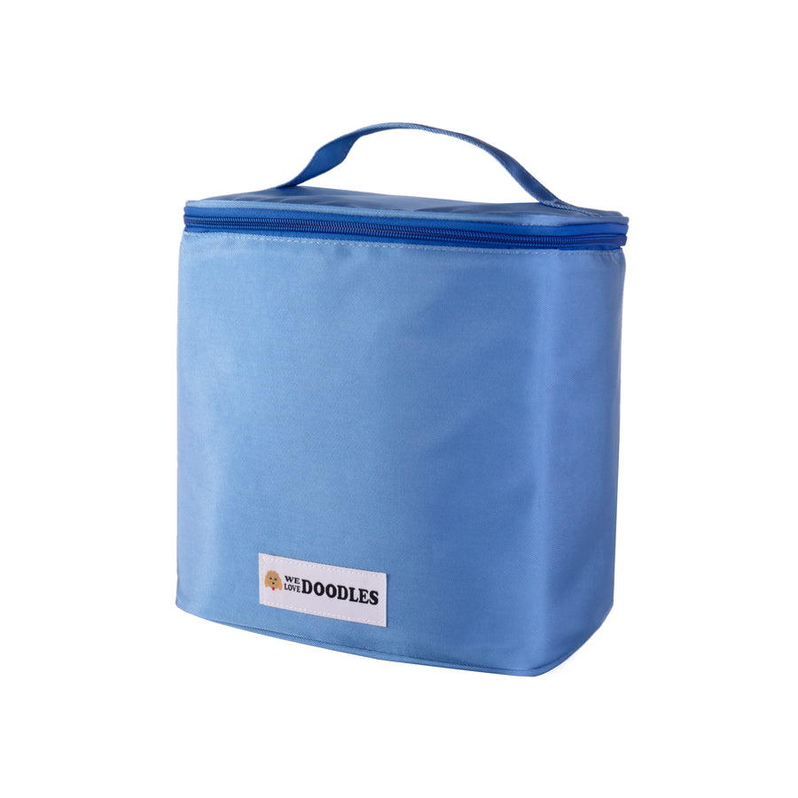 Soft sided light blue bag shown closed with a zip lid and a top handle. The front We Love Doodles logo patch is visible.