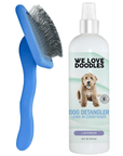 A blue slicker brush with long bent pins stands beside a white bottle labeled Dog Detangler Leave In Conditioner lavender on a clean white background.