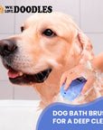 Close view of a wet dog in a tub while a hand scrubs with a blue bath brush covered in soap suds. Text reads Dog Bath Brush for a Deep Clean.