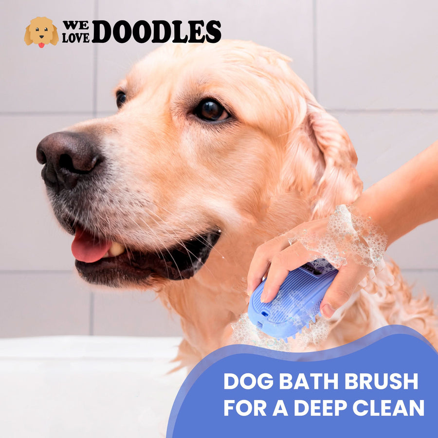 Close view of a wet dog in a tub while a hand scrubs with a blue bath brush covered in soap suds. Text reads Dog Bath Brush for a Deep Clean.