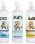 Three 16 oz white spray bottles labeled Dog Detangler Leave in Conditioner in Ocean Breeze Lavender and Mango scents on clean color backdrops.
