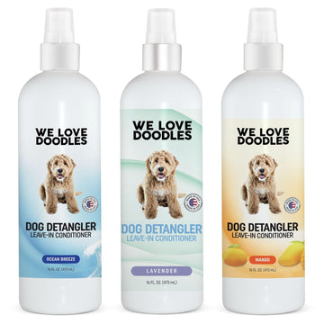 Three 16 oz white spray bottles labeled Dog Detangler Leave in Conditioner in Ocean Breeze Lavender and Mango scents on clean color backdrops.