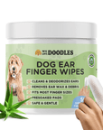 White jar with a light green label that reads Dog Ear Finger Wipes. A hand shows a white textured finger sleeve beside the jar. An aloe plant sits in front and the label lists cleaning benefits.