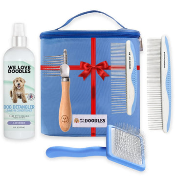 Blue zip grooming bag with ribbon graphic shown with a detangler bottle a wood handle dematting rake two white and blue metal combs and a blue slicker brush on a white background.