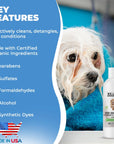 White dog with wet fur sits in a blue towel next to a We Love Doodles shampoo bottle. A panel lists key features made with certified organic ingredients no parabens no sulfates no formaldehydes no alcohol no synthetic dyes and a Made in USA graphic.