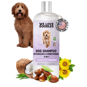 White bottle with a purple label reading dog shampoo detangler and conditioner 4 in 1. A fluffy brown dog sits beside it with a Made in USA tag near the cap. Coconut half sunflower heads and jojoba seeds are at the base.
