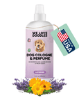 White We Love Doodles Dog Cologne and Perfume bottle with a lavender label and spray cap. A mint tag reads Made in USA. Lavender stems and yellow calendula flowers sit at the base on a white background.