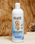 Single 16 oz Ocean Breeze dog shampoo bottle on a cream surface with soft brown fur behind it. Label reads Detangler and Conditioner 4 in 1.