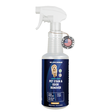 Clear trigger spray bottle with a blue We Love Doodles label that reads Pet Stain and Odor Remover Lemon Thyme. A Made in the USA badge hangs near the neck on a white background.