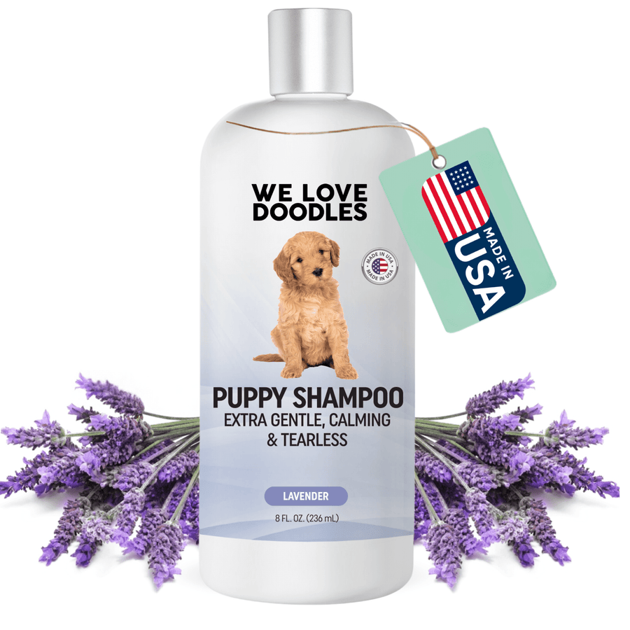 White 8 fl oz bottle labeled Puppy Shampoo extra gentle calming and tearless with a puppy on the label. Lavender sprigs surround the bottle and a green tag reads Made in USA.
