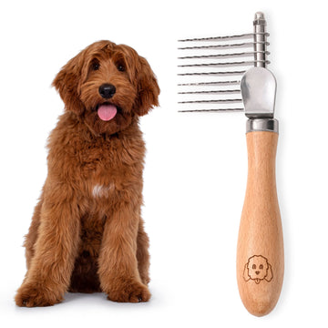 Fluffy brown dog sits next to a small dematting rake with nine stainless steel blades and a smooth wood handle on a white background.