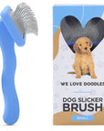 Blue small slicker brush with long bent pins shown beside the retail box that features a puppy image and the label Dog Slicker Brush Small.