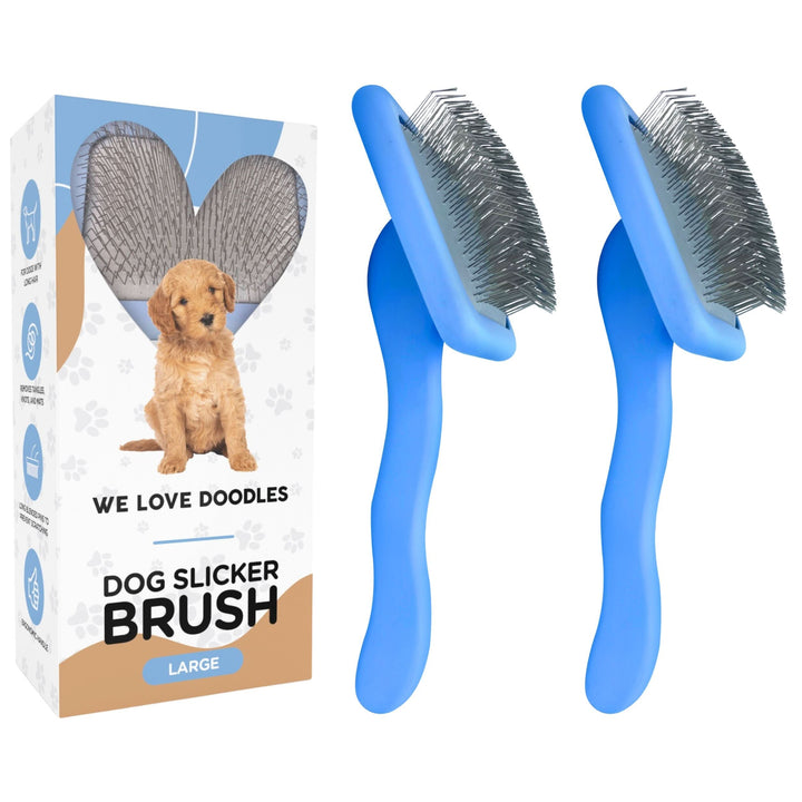 On a white background two large blue slicker brushes with bent stainless pins sit beside a branded We Love Doodles box with a puppy graphic.
