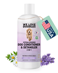 White 16 fl oz bottle with a purple label that reads dog conditioner and detangler 2 in 1. Lavender and chamomile flowers sit near the base and a Made in USA tag hangs from the neck.