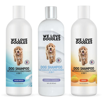 Front view of three 16 oz We Love Doodles dog shampoo bottles. Scents shown are Ocean Breeze Lavender and Chamomile and Mango. Labels read dog shampoo detangler and conditioner 4 in 1.