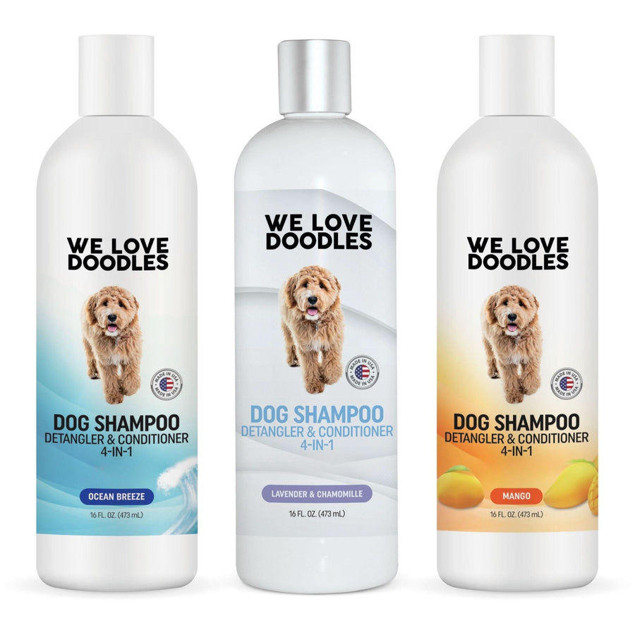 Front view of three 16 oz We Love Doodles dog shampoo bottles. Scents shown are Ocean Breeze Lavender and Chamomile and Mango. Labels read dog shampoo detangler and conditioner 4 in 1.