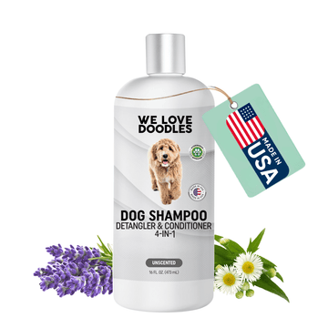 White 16 fl oz We Love Doodles dog shampoo bottle labeled 4 in 1 detangler and conditioner with a Made in USA tag, lavender and chamomile flowers on a white background.
