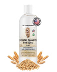 White bottle labeled premium Oatmeal Shampoo for Dogs with 5 in 1 benefits. A round Made in the USA tag hangs near the cap. Loose oats and wheat surround the base on a clean white background.

